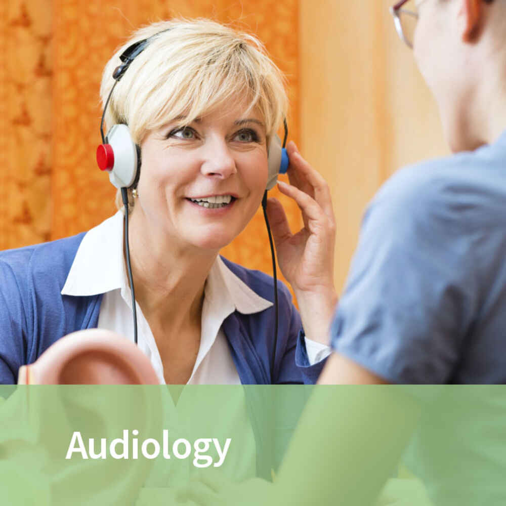 Audiologist conducting a hearing test with a patient