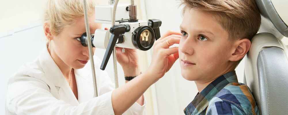 ENT doctor examining pediatric patient's ear