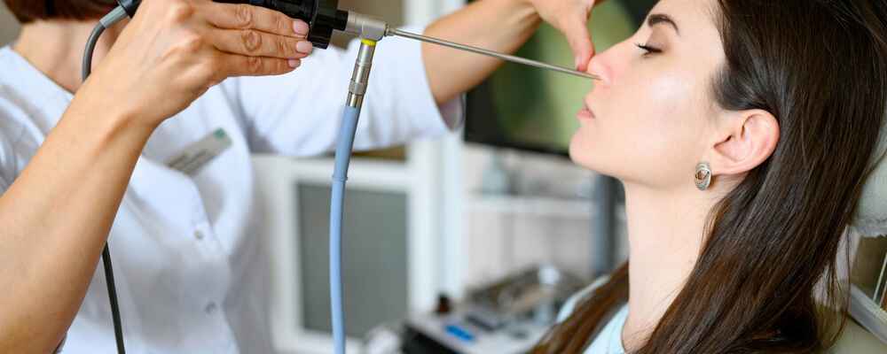 ENT doctor using nasal endoscopy on patient to check for sinus issues